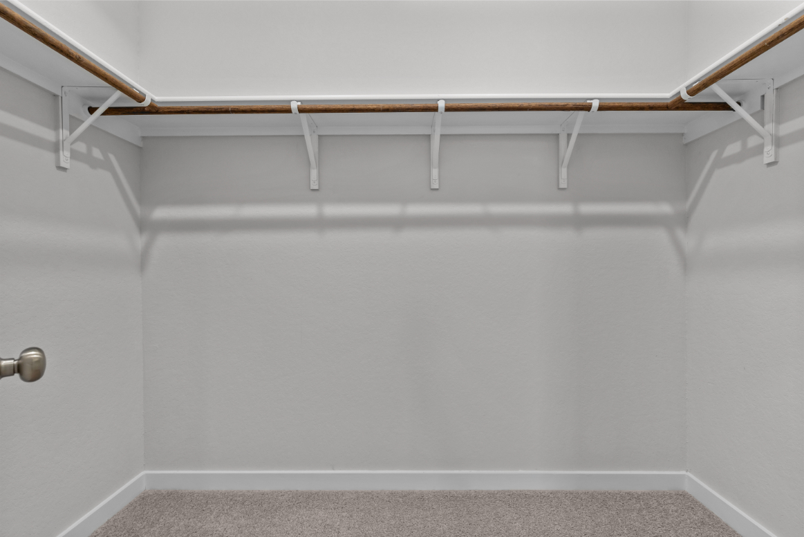 A white wall with a metal railing.