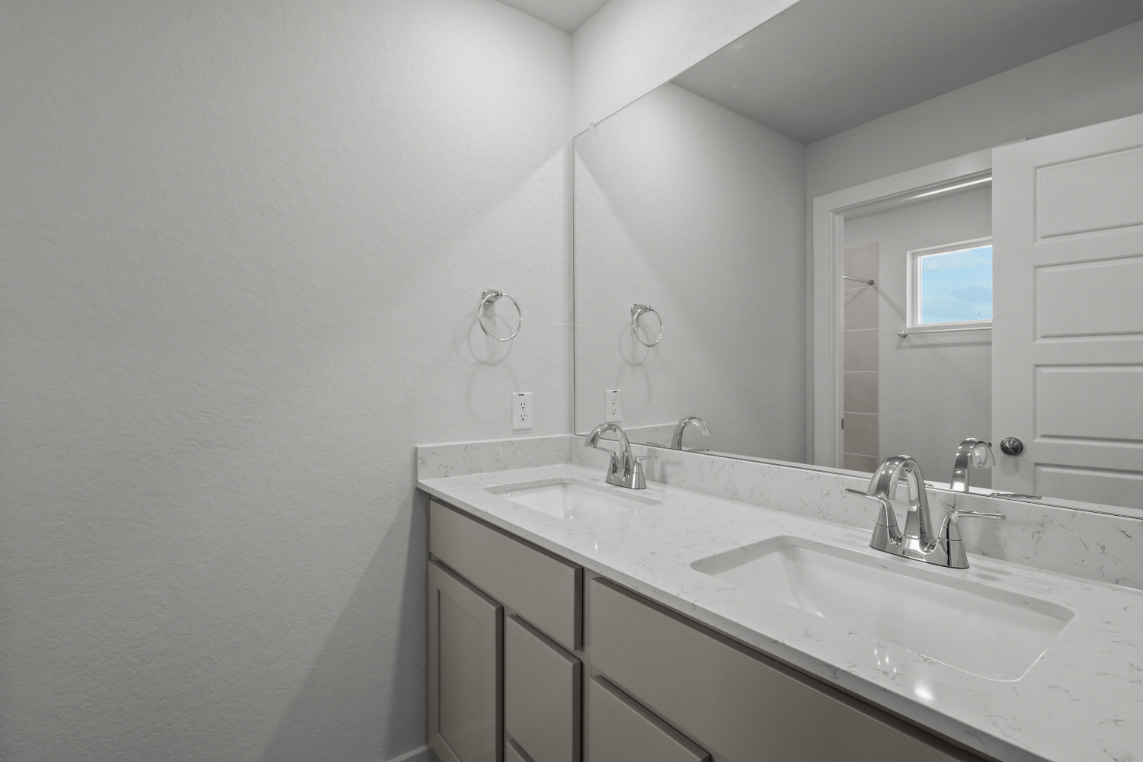 A bathroom with a large mirror.