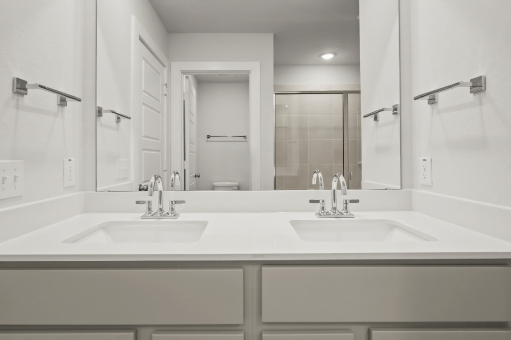 A bathroom with a large mirror.