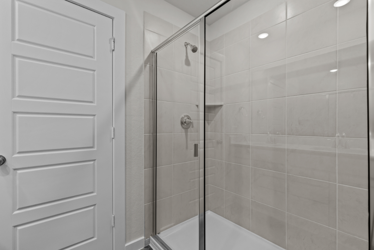 A shower with a glass door.