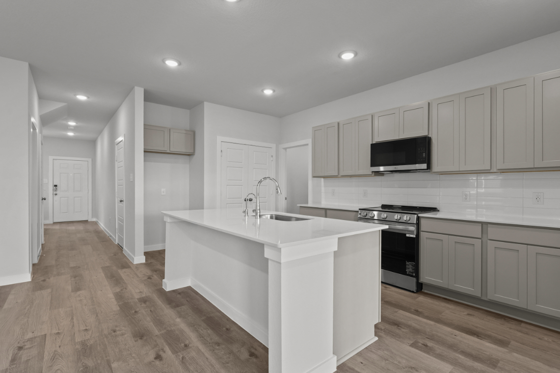A kitchen with white cabinets.
