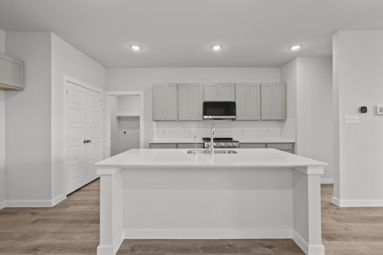 A white kitchen with a white counter.
