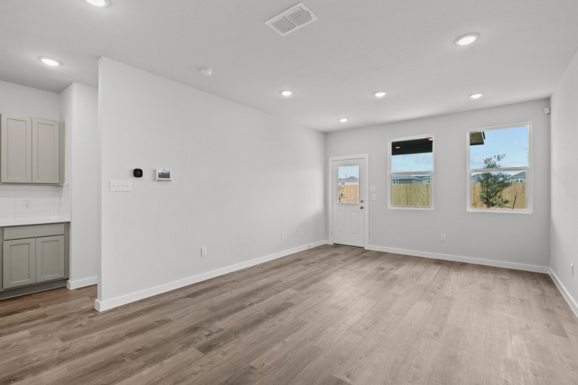 A room with white walls and a wood floor.