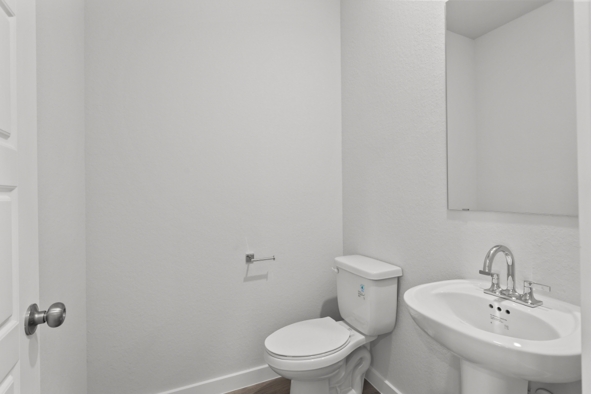 A bathroom with a toilet and sink.