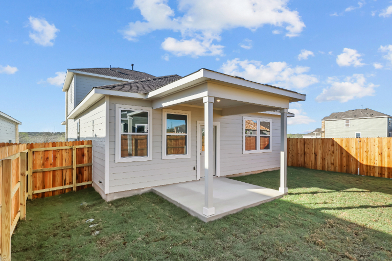 A small house with a fence.