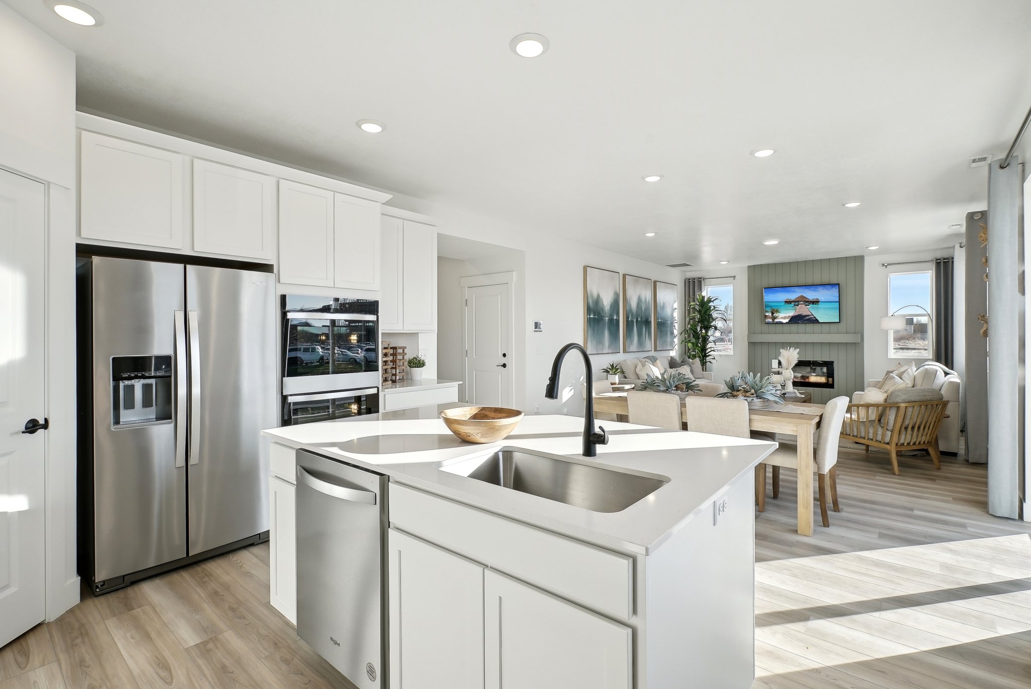 A kitchen with white cabinets.