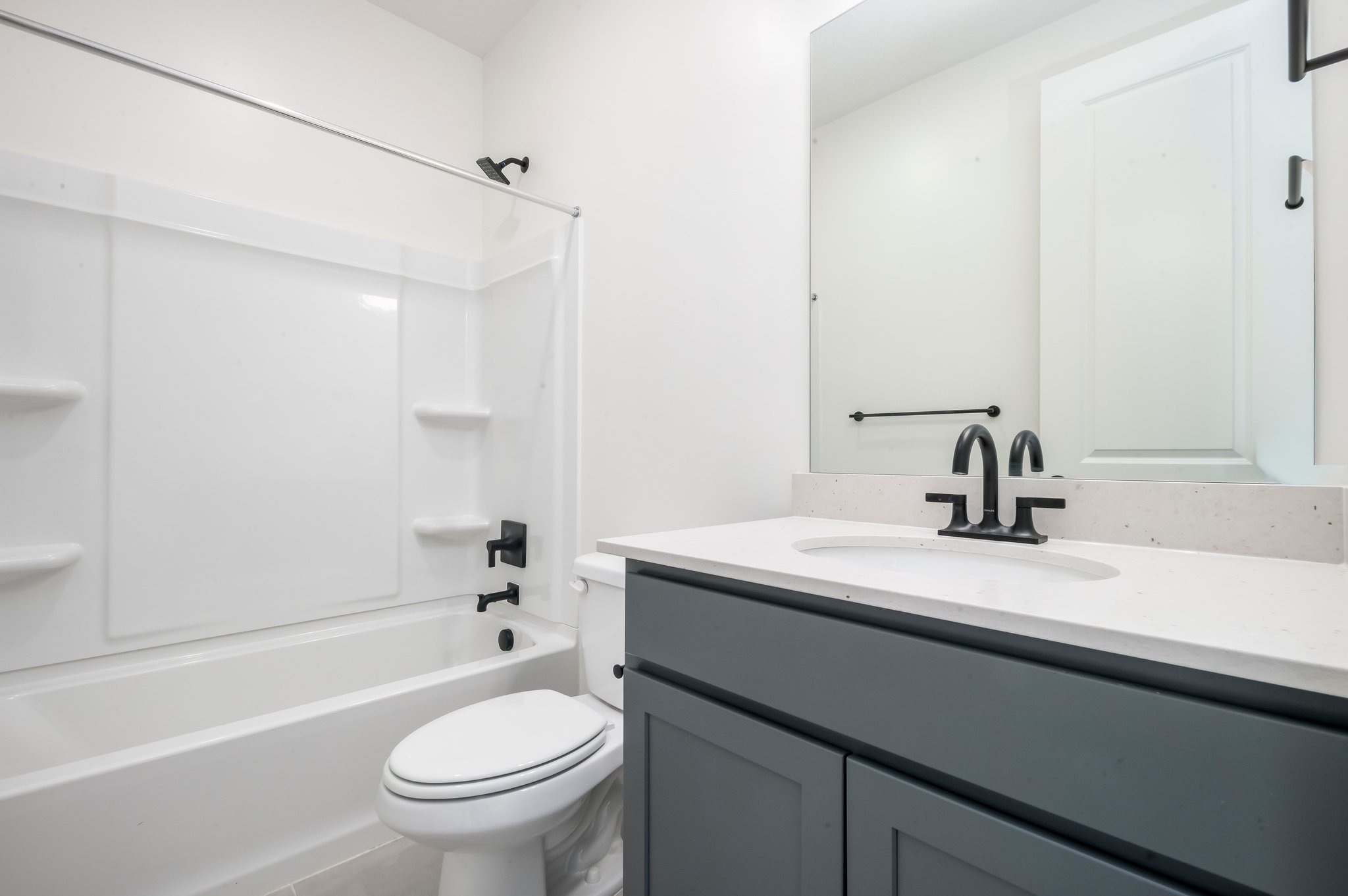 A bathroom with a sink toilet and bathtub.