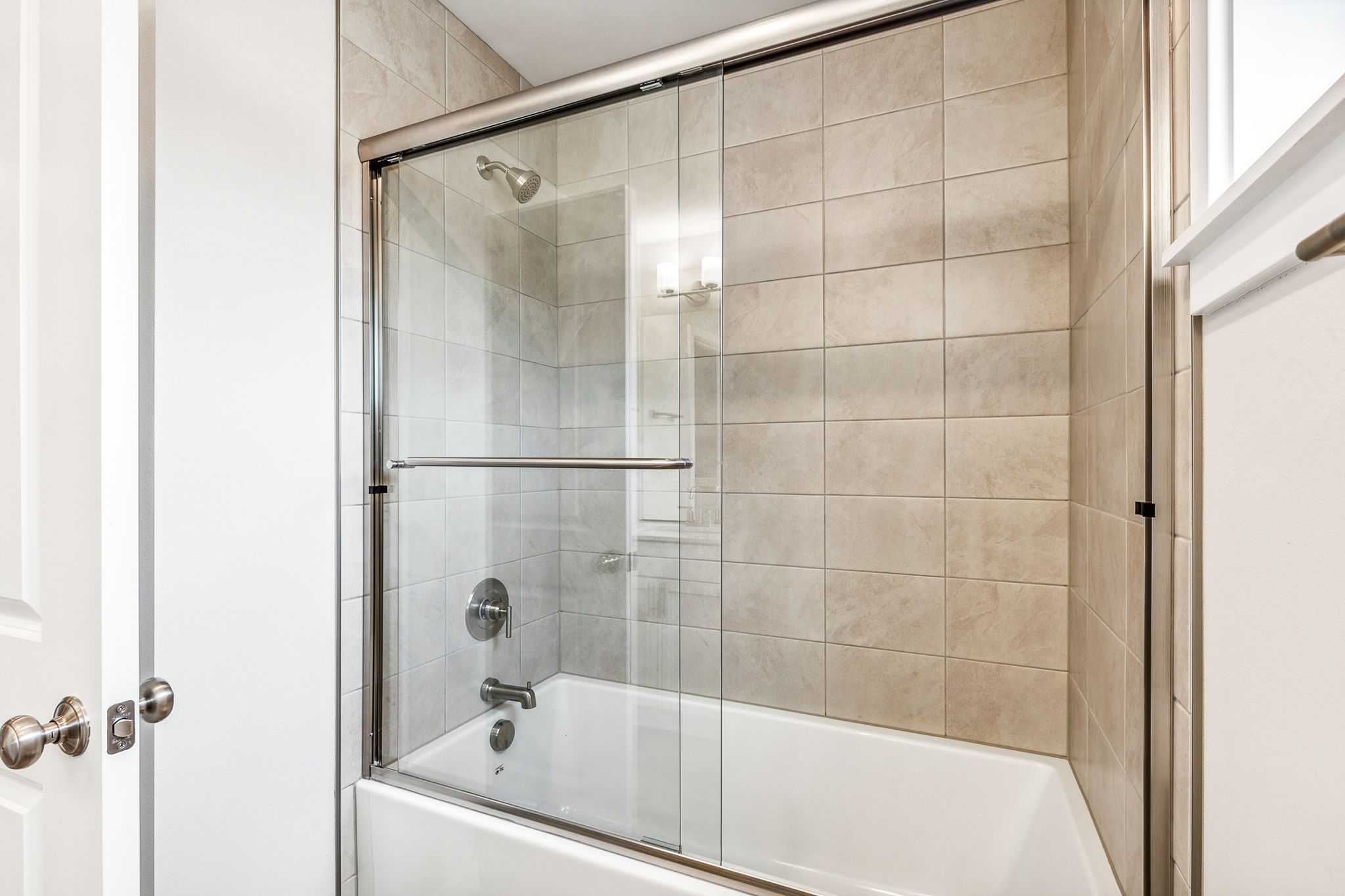 A shower with a glass door.
