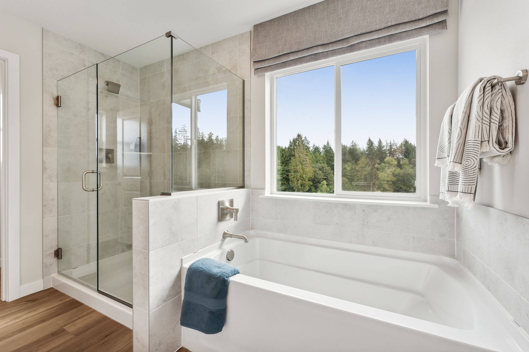 A bathroom with a tub and a window.
