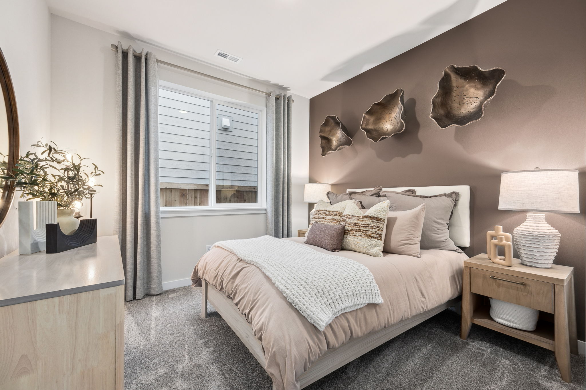 A bedroom with a bed and a table.