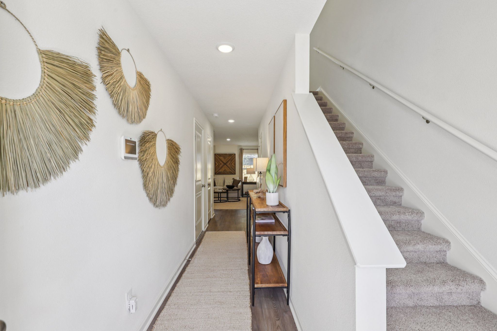 A staircase with a table and chairs.
