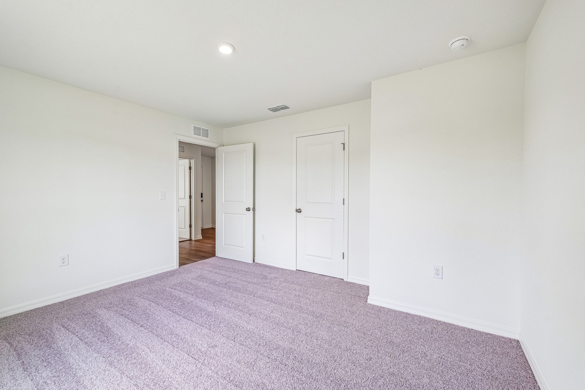 A hallway with white doors.