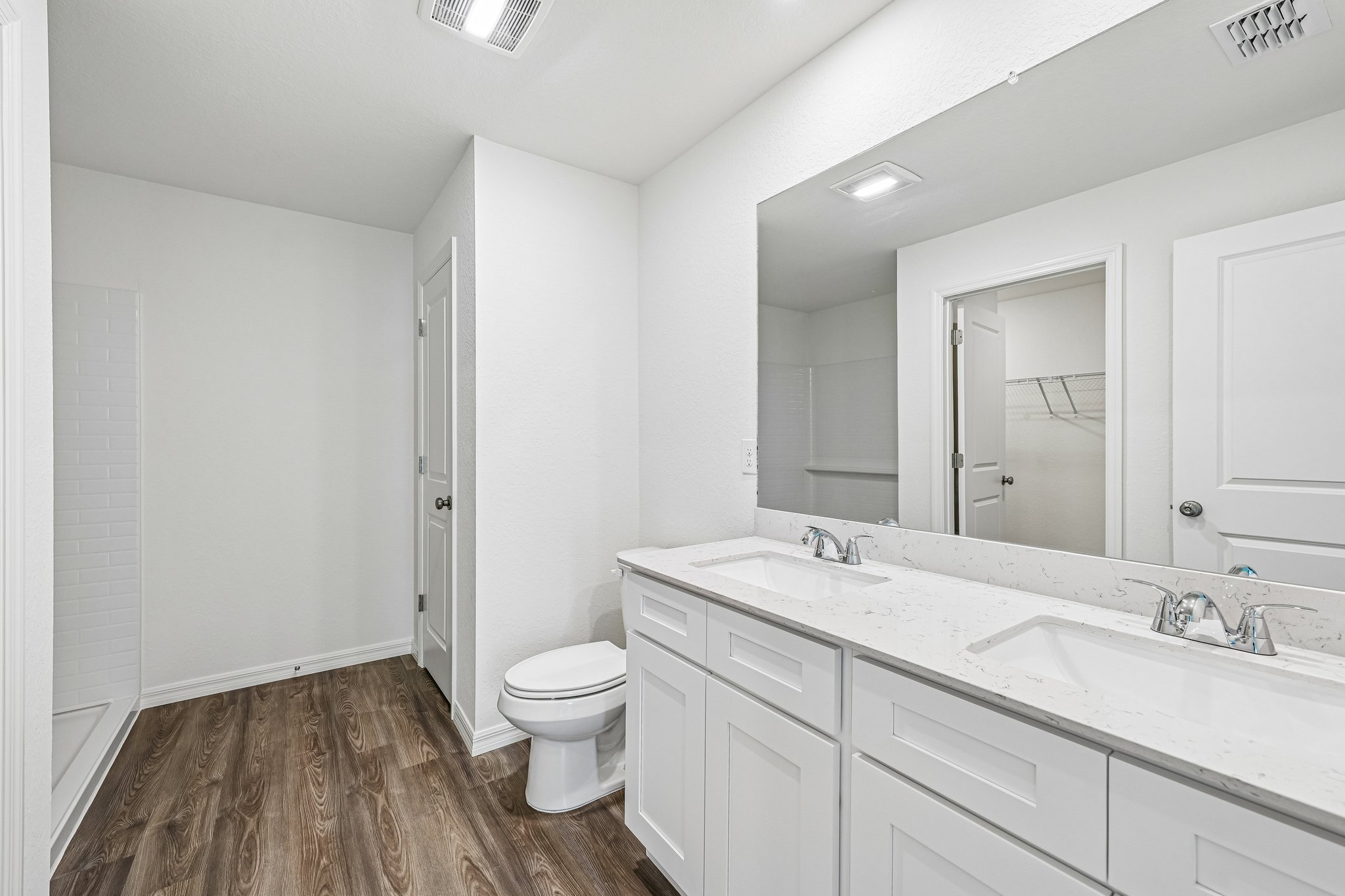 A bathroom with a large mirror.