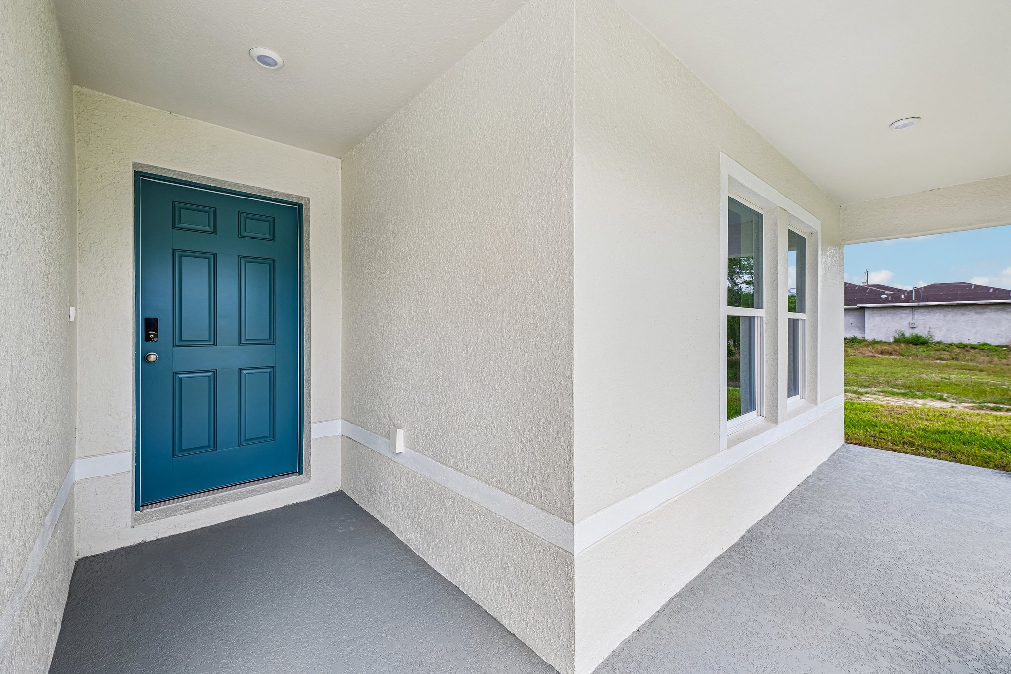 A white house with blue doors.