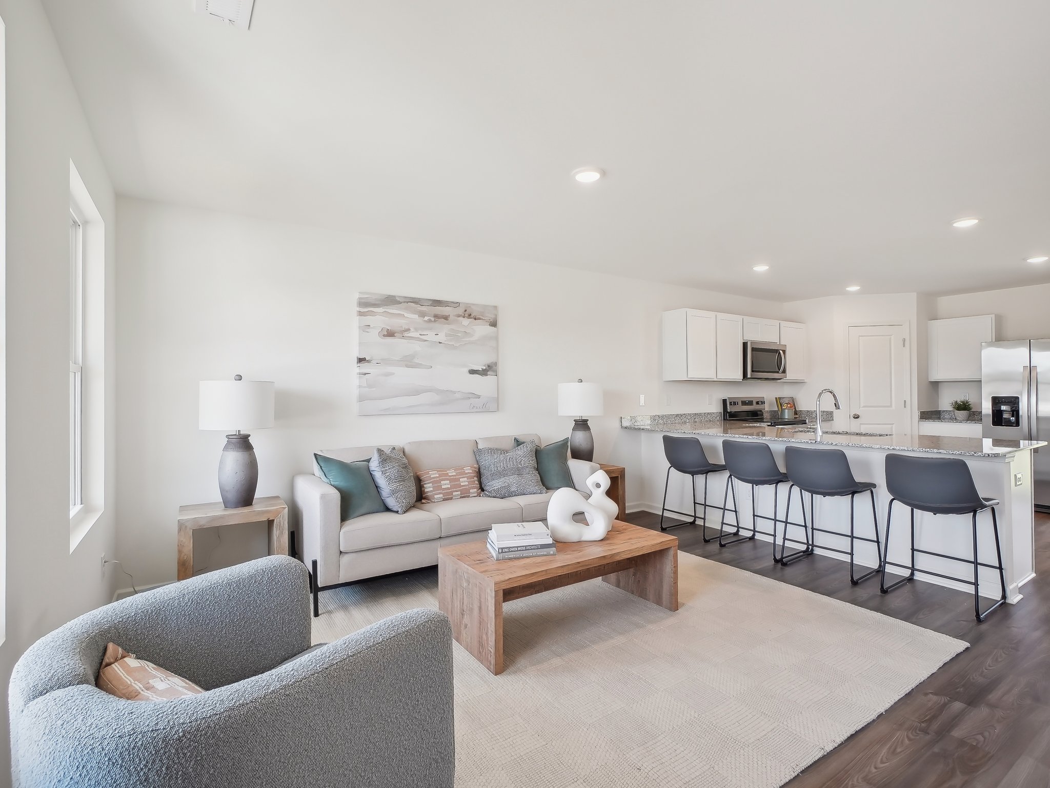 A living room with a couch and chairs.