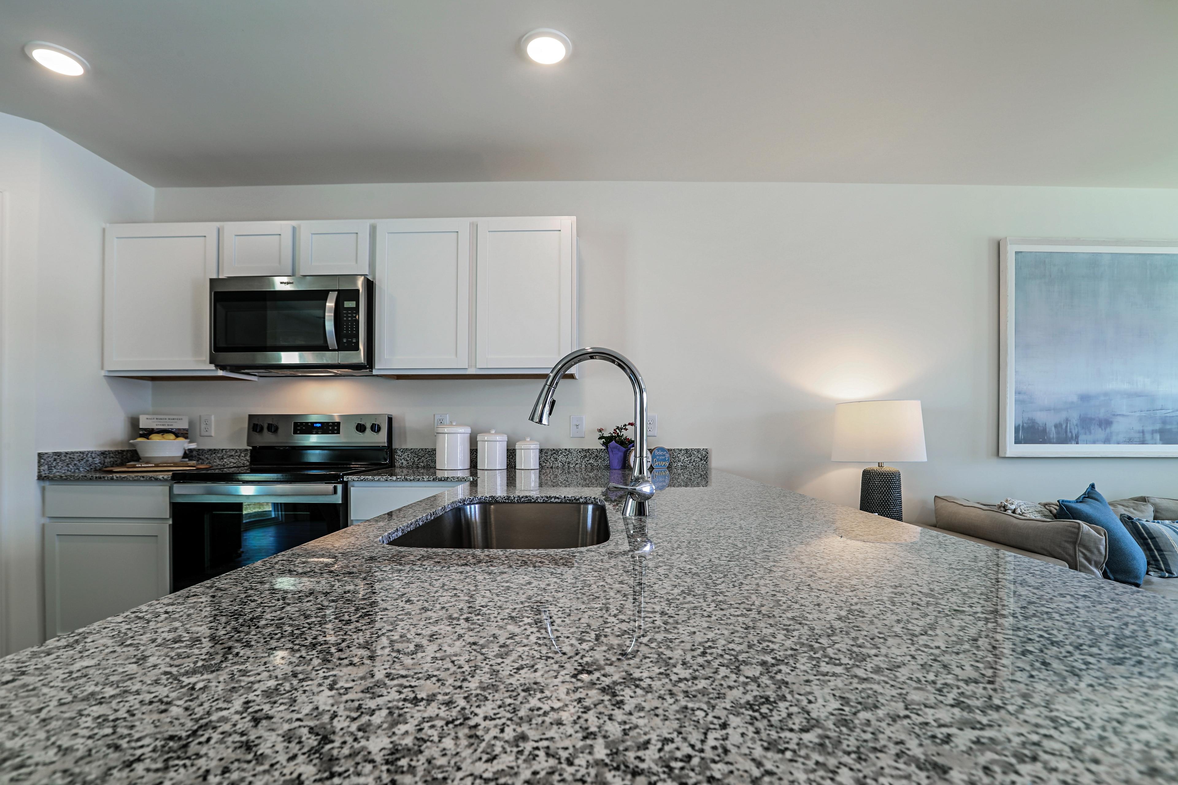 A kitchen with marble counters.