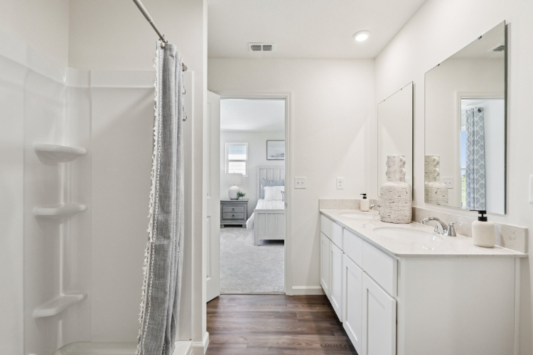 A bathroom with a sink and a mirror.