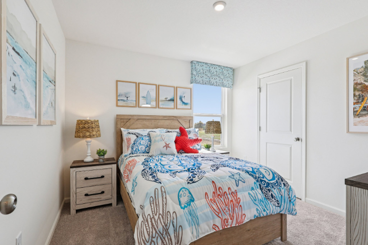 A bedroom with a bed and a lamp.