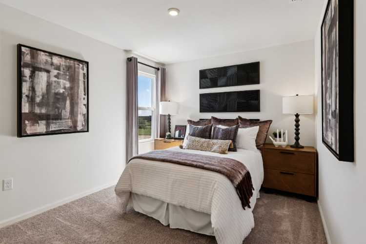 A bedroom with a bed and lamps.