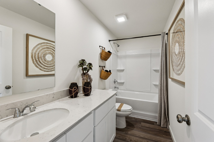 A bathroom with a sink toilet and a shower.