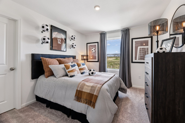 A bedroom with a large window.