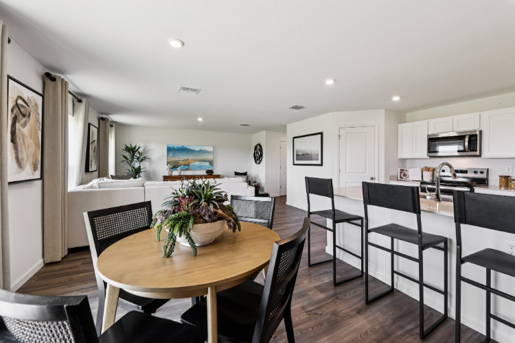 A kitchen with a dining table.