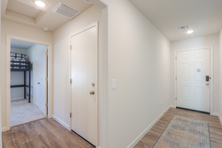 A hallway with white doors.
