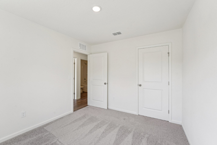 A hallway with white doors.