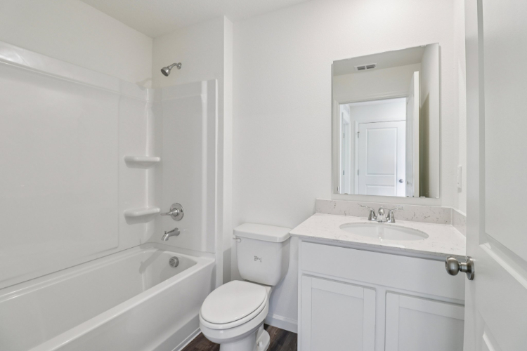 A bathroom with a toilet sink and bathtub.