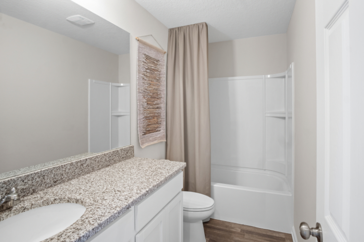 A bathroom with a marble countertop.
