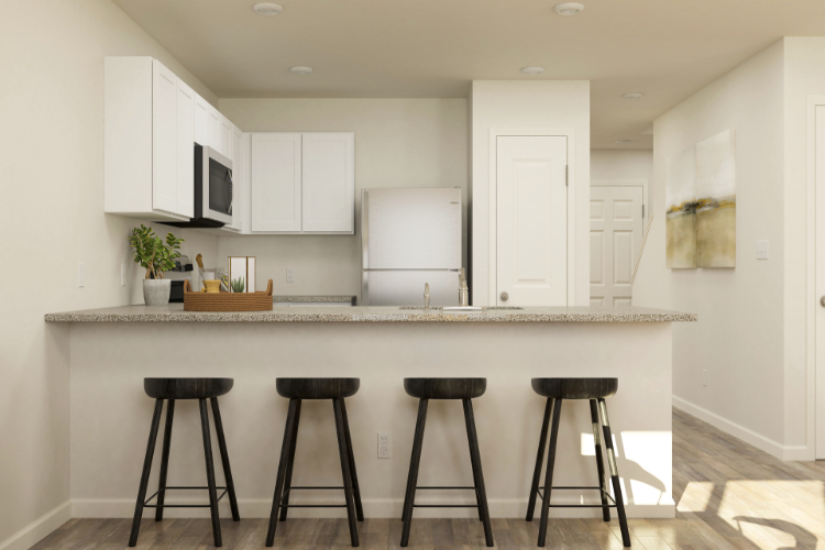 A kitchen with stools and a counter top.